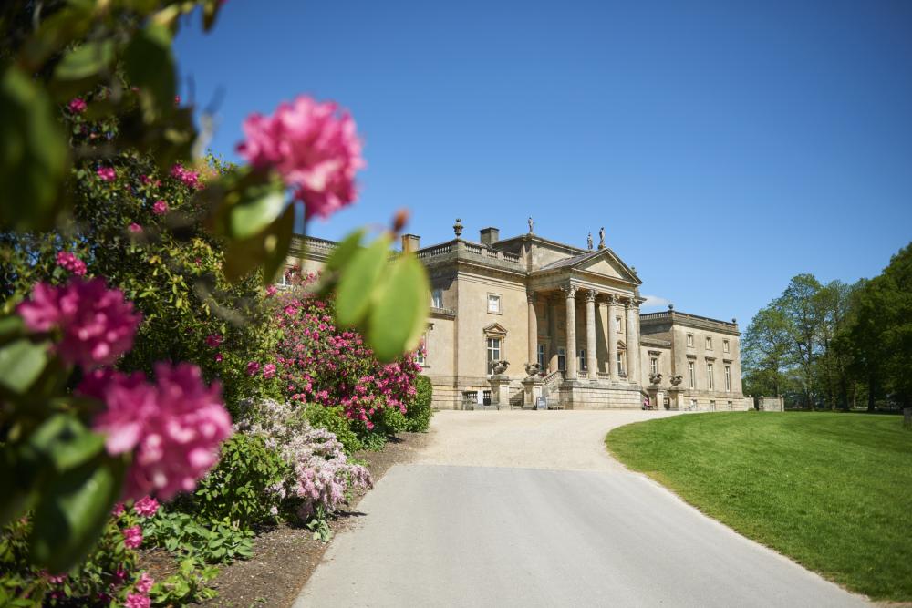 Stourhead house framed by pink rhododendrons in spring. National Trust Images Trevor Ray Hart
