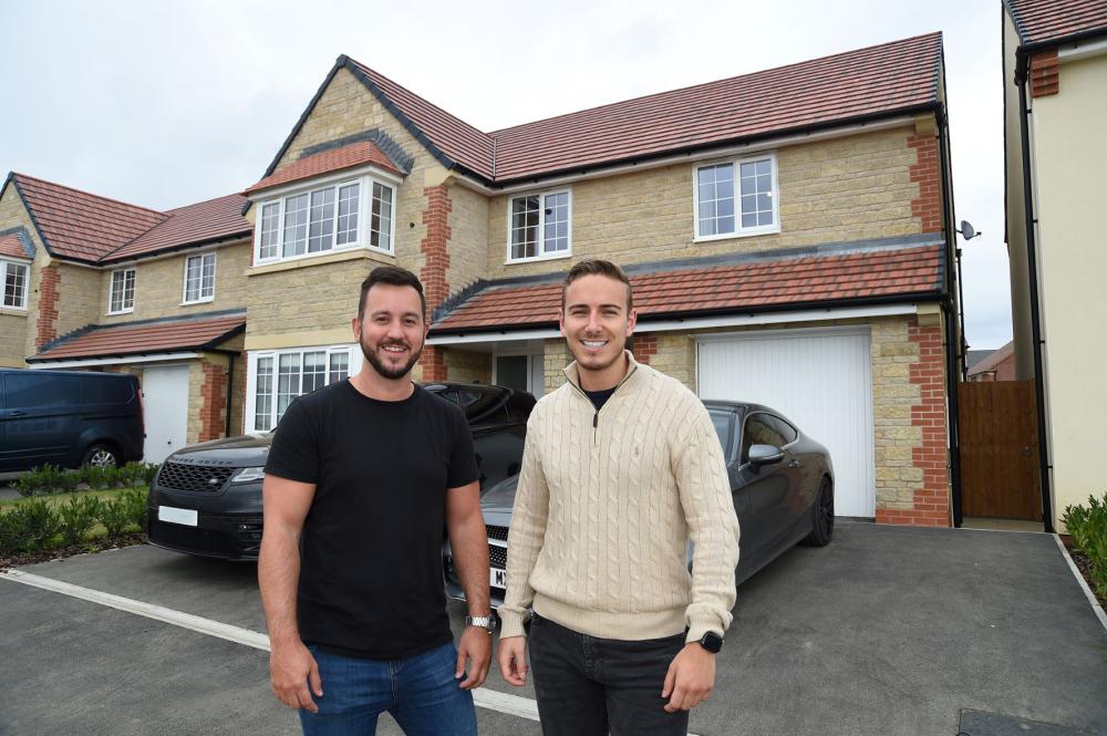Nathan and Max outside their new property