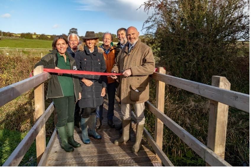 Bay Meadows Opening Event - Mike Hill from The Hills Group cutting the ribbon with (left to right): Joanna Lewis (WWT), Alan Pardoe (The Hills Group), Ninna Gibson (Deputy Lord Lieutenant of Wiltshire), Nick Holliday (National Lottery Heritage Fund) and Dr Gary Mantle (former CEO of WWT)