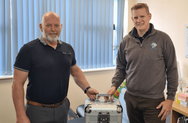 Kube Medical Director Patrick Campbell, right, takes delivery of the equipment from KLaser’s Derek Tillotson 