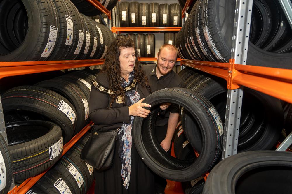 Cllr Barbara Parry checks some of Kwik Fit's Swindon tyre stock under the guidance of centre manager Daryl Bown