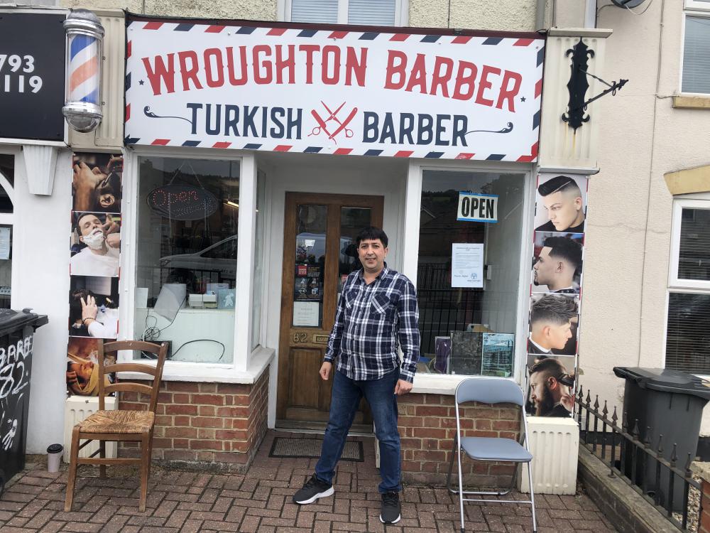 Mr Dertlicoban outside his shop