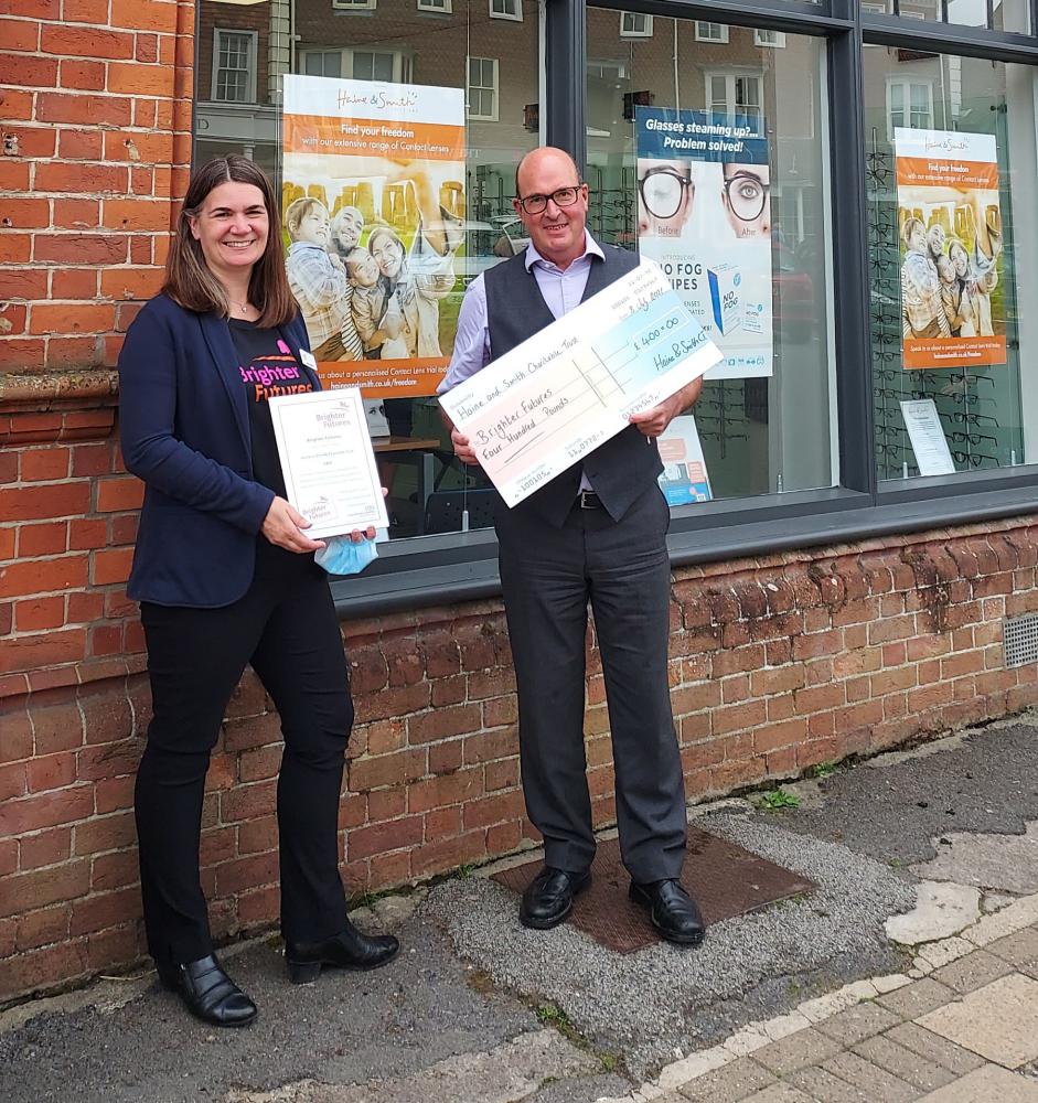 Jane Leighton, Major Gifts Manager at Brighter Futures receiving the cheque from Haine & Smith Optometric Partner Mark Saunders