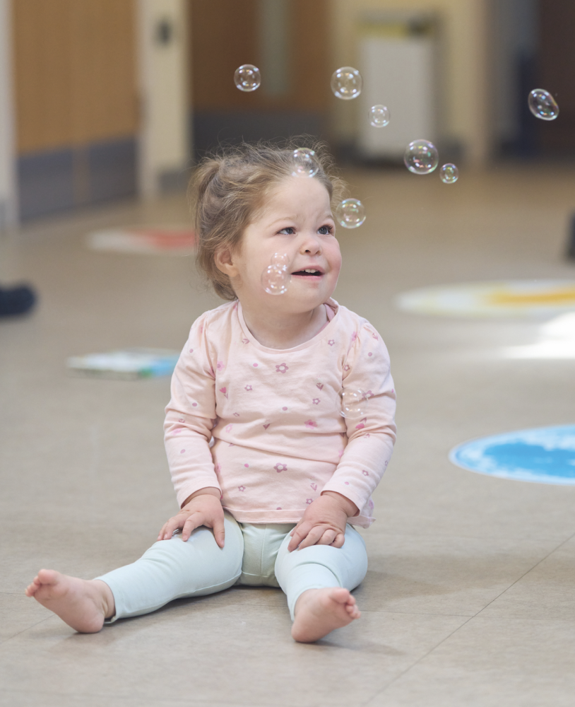 Millie having fun with bubbles at the hospice