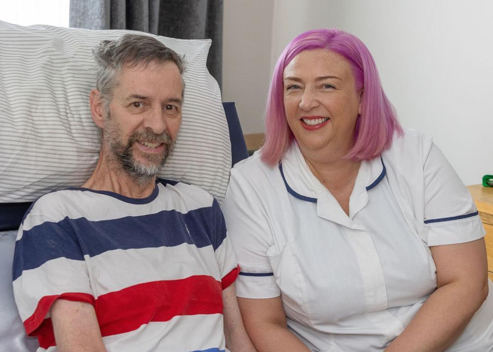 Care Co-ordinator Dorinda Moffatt sitting with patient Dale Rose