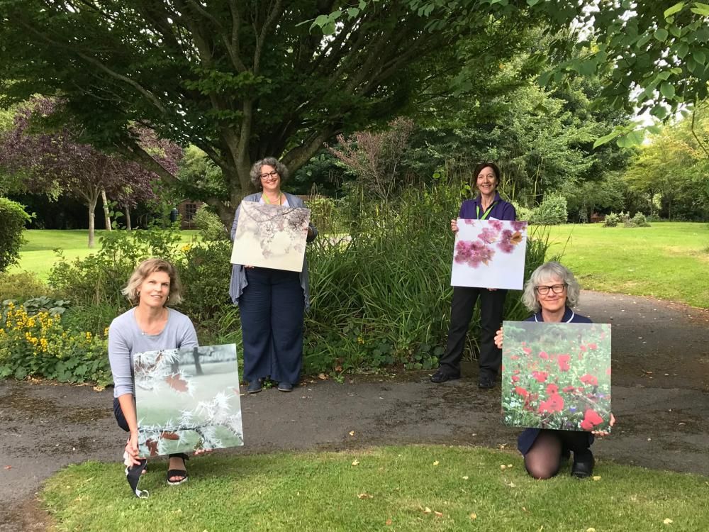 Holding some of the images are, back left to right, Carolyn Bell, director of service and Dr Shelia Popert, medical director, and front, left to right, Kirsten Murphy and Jacqui Gullis, clinical lead  