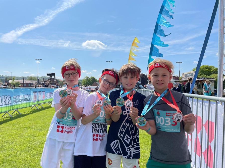 Team Daring Dragons having just completed the Knight Frank Schools Triathlon and received their Champion of Change medal for being top fundraisers. (Photo: Restless Development)