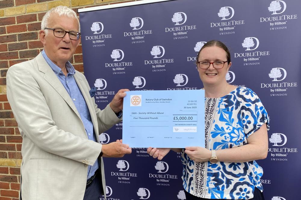 Jeremy Holt presents Kate Rowland with the donation
