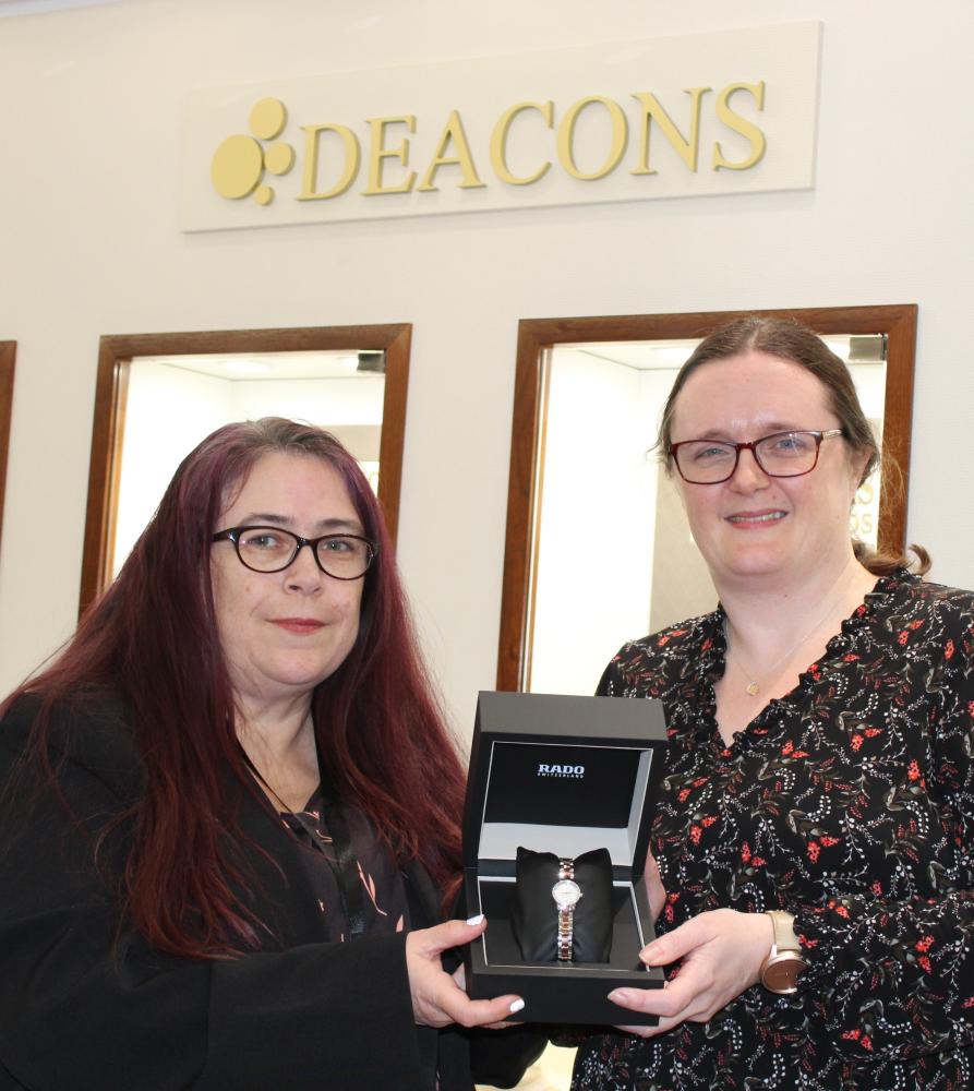 Tracie Cox from Deacons, left, and Kate Rowland from SWA with the diamond watch donated by Deacons for the SWA 50 for 50 auction
