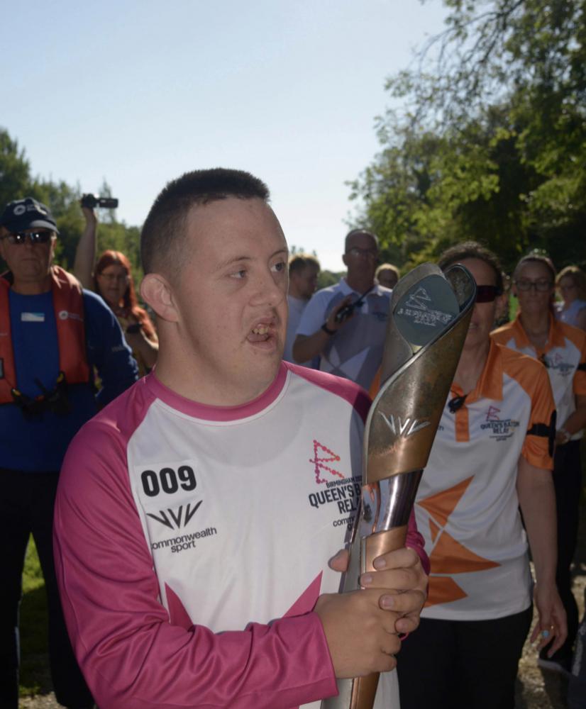 Sam Russell-Pierce holding the Queen's Baton