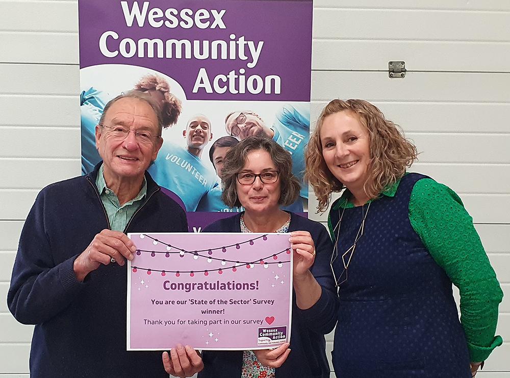 Wessex Community Action chief executive Amber Skyring, right, presents a voucher to South Wilts Mencap trustees Linda Lane and Nigel Afford. All survey respondents were entered into a draw