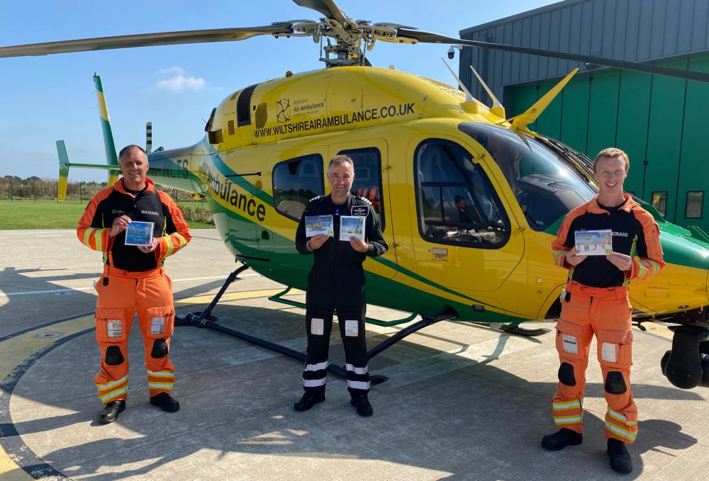 From left: Critical care paramedic Richard Miller, pilot Simon Gough and critical care paramedic Craig Wilkins show off the charity’s new Christmas cards