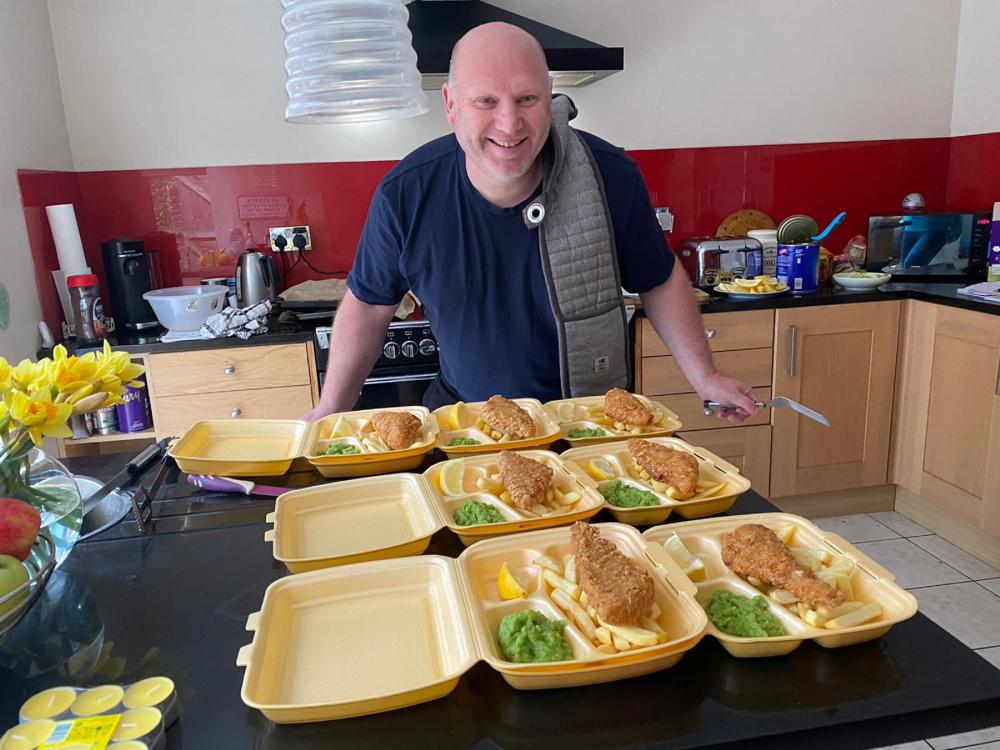 Stratton Juniors chairman Magnus Painter with hot meals ready for delivery