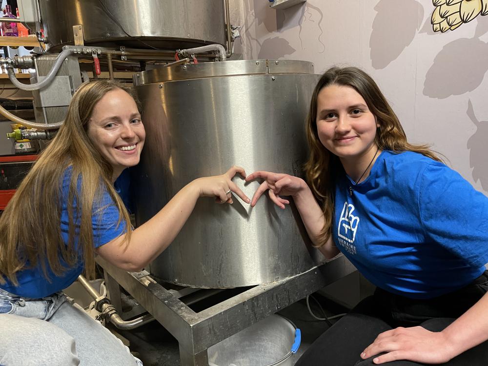 Ieva Delininkaityte (left) and Yana Shatoka (right) with the batch of beer they are brewing at the Hop Kettle