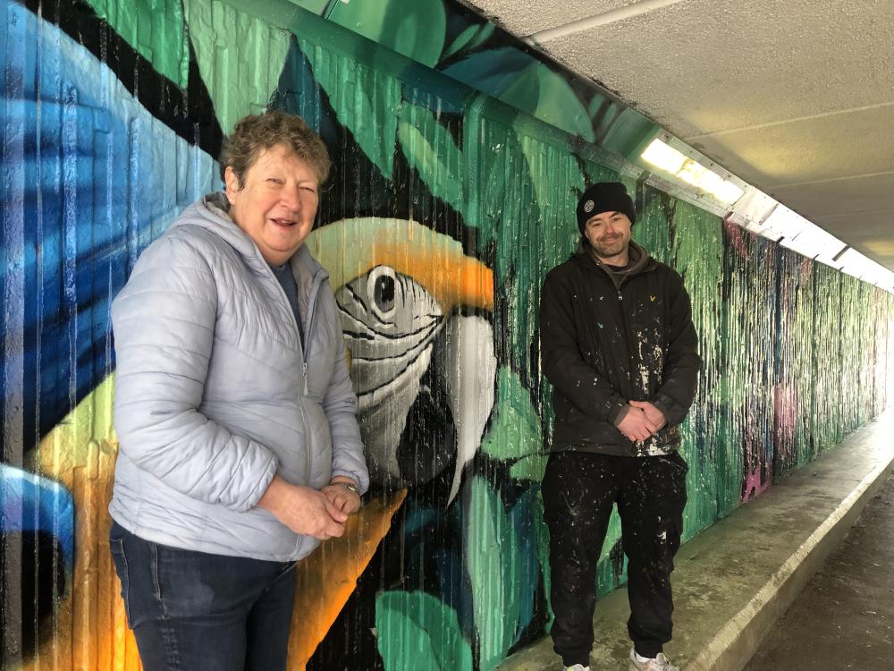 Vice Chair, Cllr Caryl Sydney-Smith with Jacksta, who has created a jungle themed mural at the Link Centre to Bodiam Drive subway  