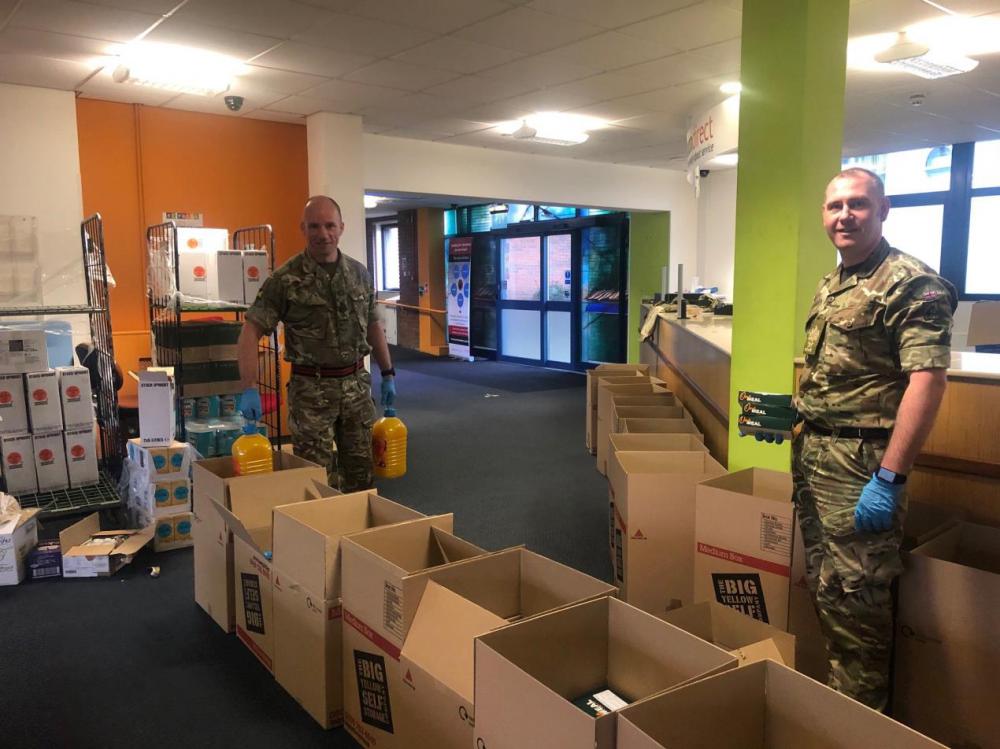 (credit Kati Wood): SSgt Alan Gray (left) with WO1 Townsend sifting through the food supply drop-off from the Department for Environment, Food and Rural Affairs.