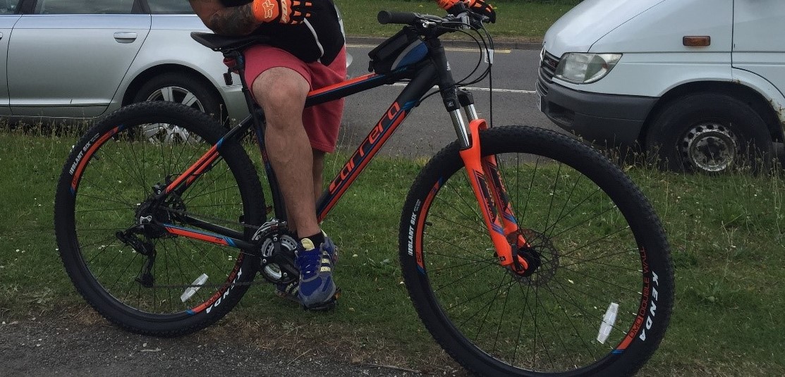 An orange and black Carrera Mountain Bike and a black iPhone 7S mobile phone were taken