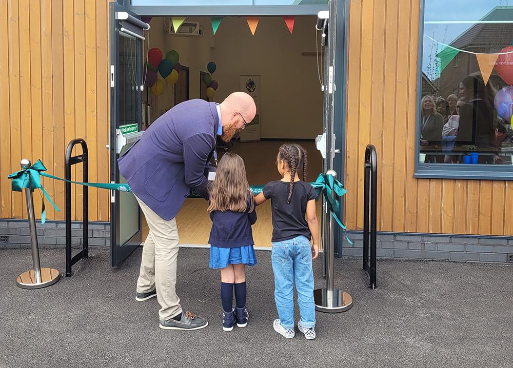 The ribbon cutting ceremony, with children helped by Mr Nowak