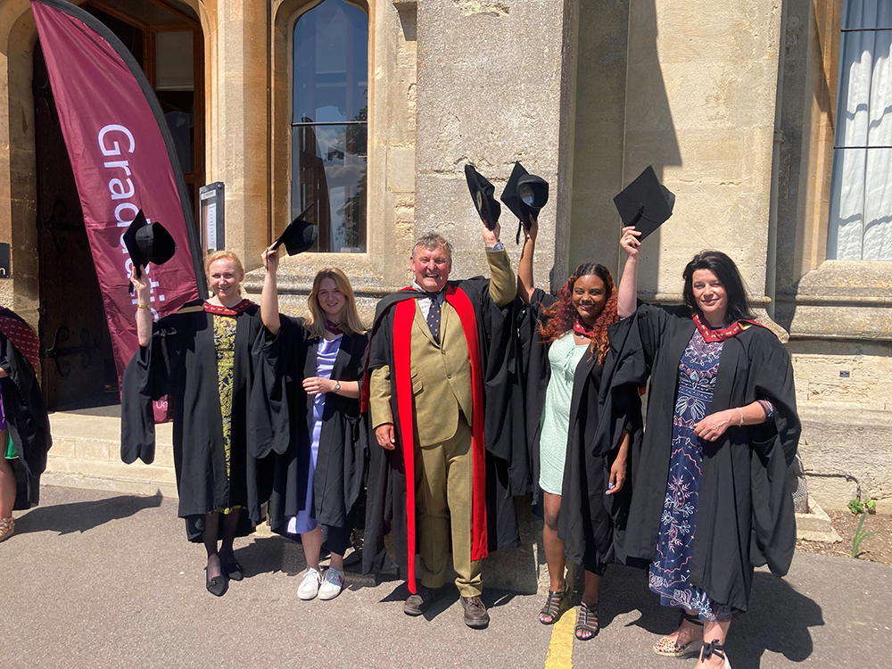 Master's students, from left, Elizabeth Cottrell, Isobel Clare, Michela Guilfoyle, and Adrienne Ridler-Lee, celebrate their graduation with Professor Mark Horton, centre, Director of the Royal Agricultural University's Cultural Heritage Institute