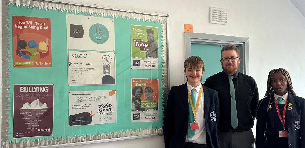 Assistant Headteacher Marek Koza with Head Pupils Eddie and Rofiat with the school's pledges