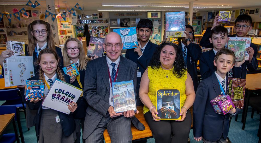 Lawn Manor Academy students pictured with the trust's Chair of Governors Nathan Coombs and Lawn Academy's Library Officer Rachel Reynolds holding some of the games which have been donated by Zatu Games