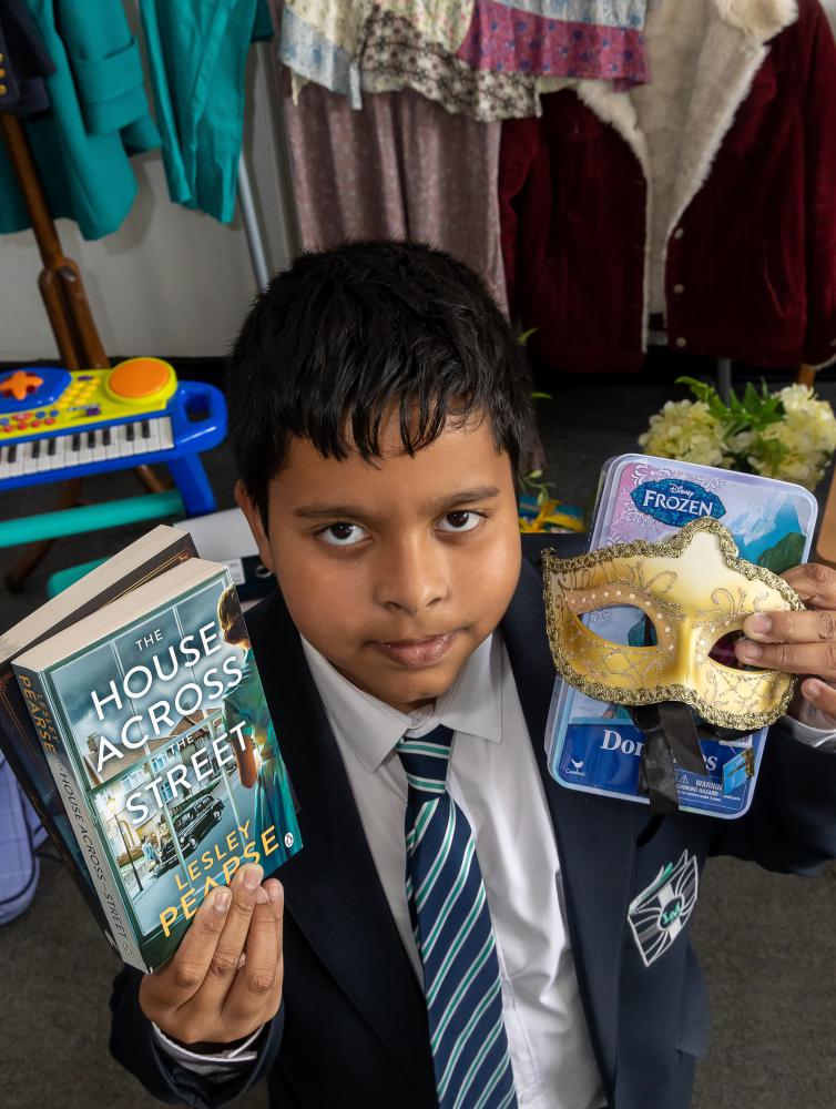 Lawn Manor Academy pupil Dwayne with some donated items for the preloved sale