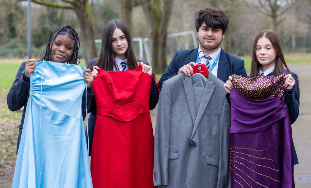 Students from Lawn Manor Academy pictured with some of the pre-loved dresses and suits