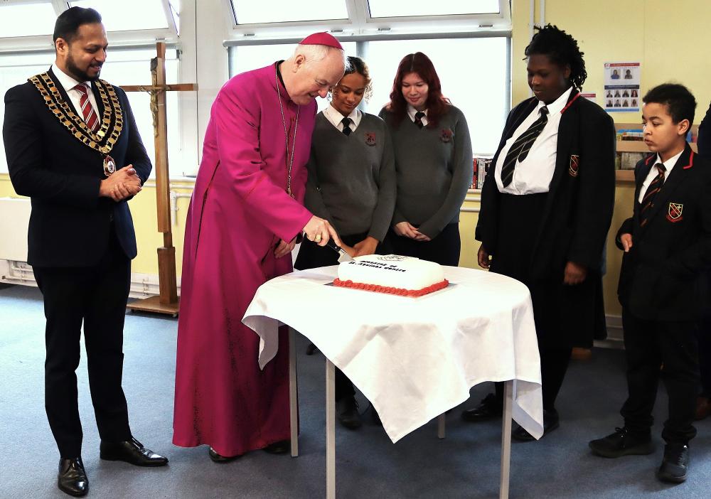 The Bishop cutting a celebratory cake as the Mayor of Swindon looks on