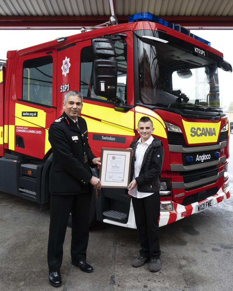 Chief Fire Officer Ben Ansell presents Kieran Tilling with his accolade