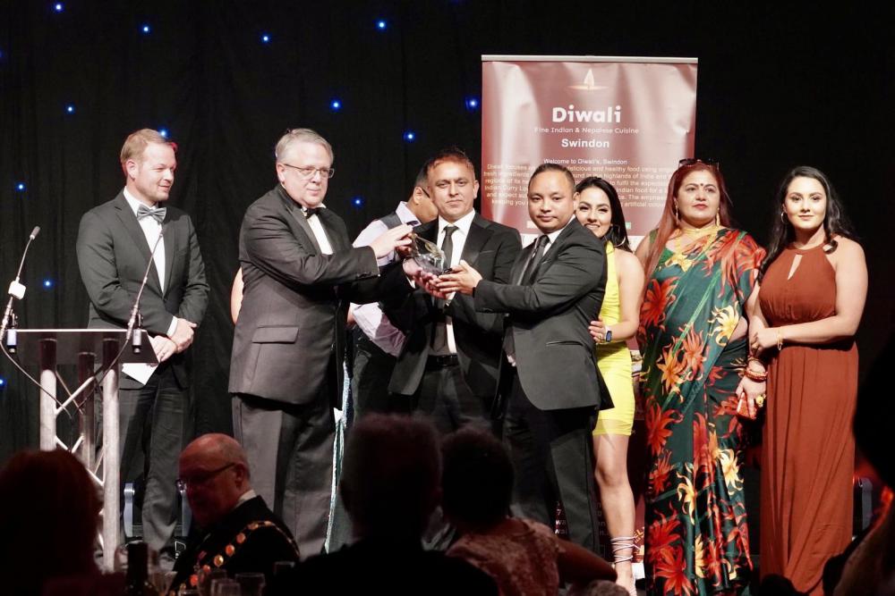 Deependra (right) and Ganga (left) accepting the restaurant's MTM award