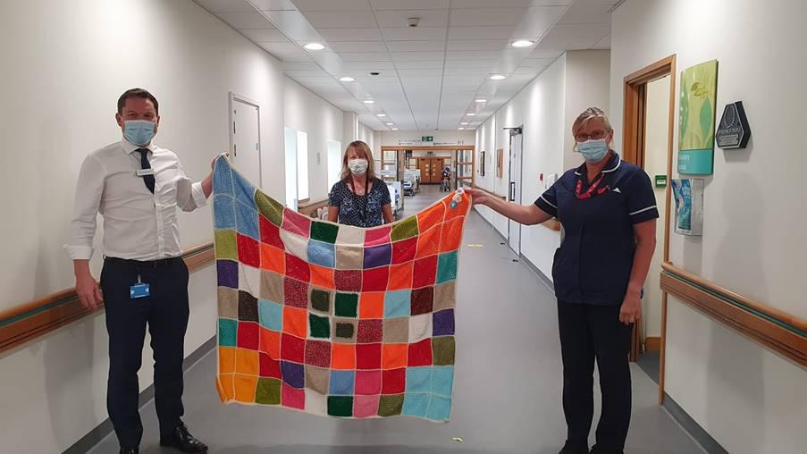 From left: Kevin McNamara, Chief Executive of Great Western Hospitals NHS Foundation Trust, Anne Norman from GWH charity Brighter Futures, Helen Brown, End of Life Clinical Nurse Specialist. The occasion was the handover of blankets knitted by members of the public for End of Life patients     