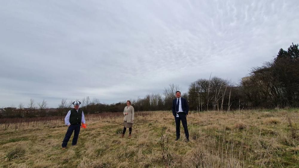 Senior personnel involved in the deal pictured at the parcel of land