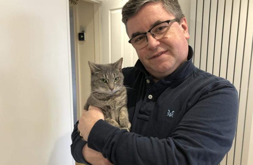 Sir Robert Buckland MP pictured with his rescue cat Mrs Landingham