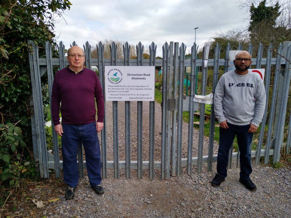 Parish councillors John Firmin, left, and Abdul Hamid at the entrance to the allotments