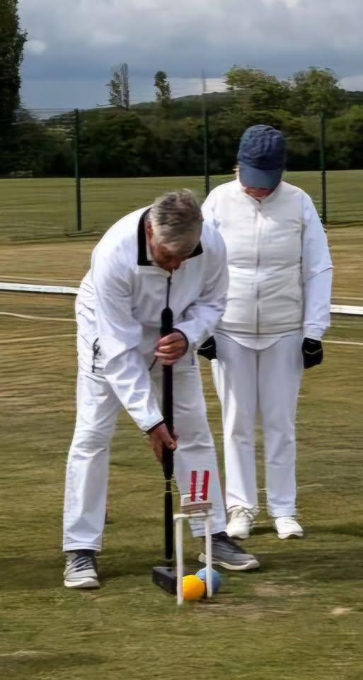 Swindon player Colin Brain being watched very closely by his opponent as he scores hoop 4 in the game against Cheltenham CC
