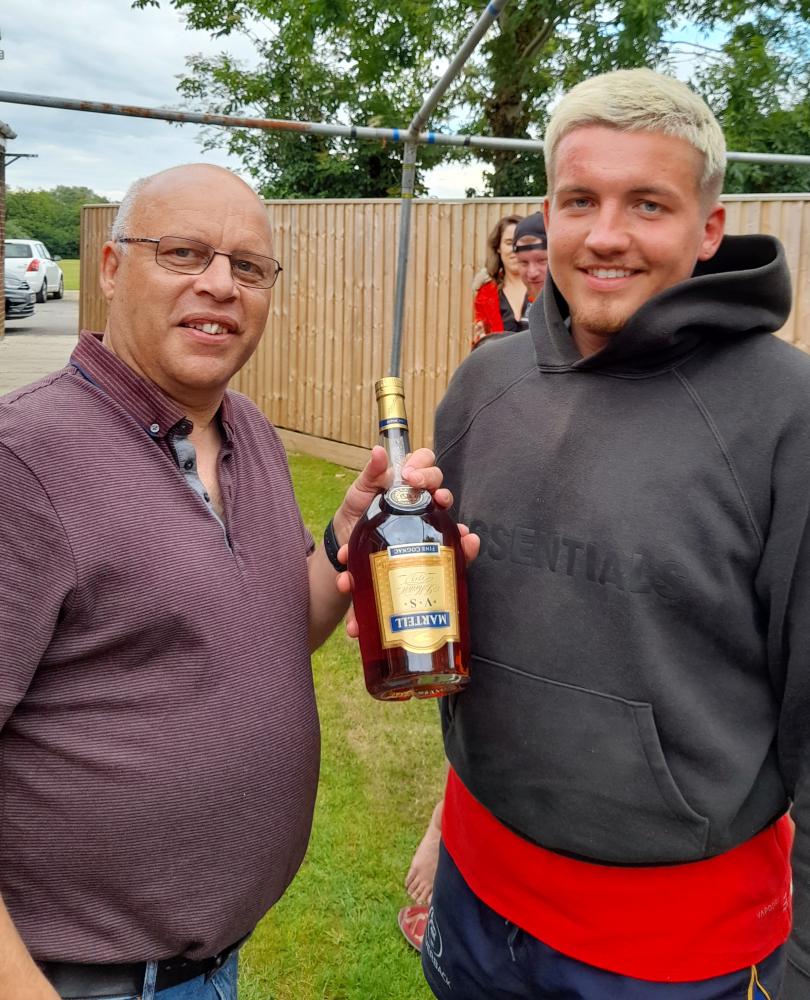 St George's Jamie Davidson receiving his Rod Evans man of the match award from club chairman Warren Huggins