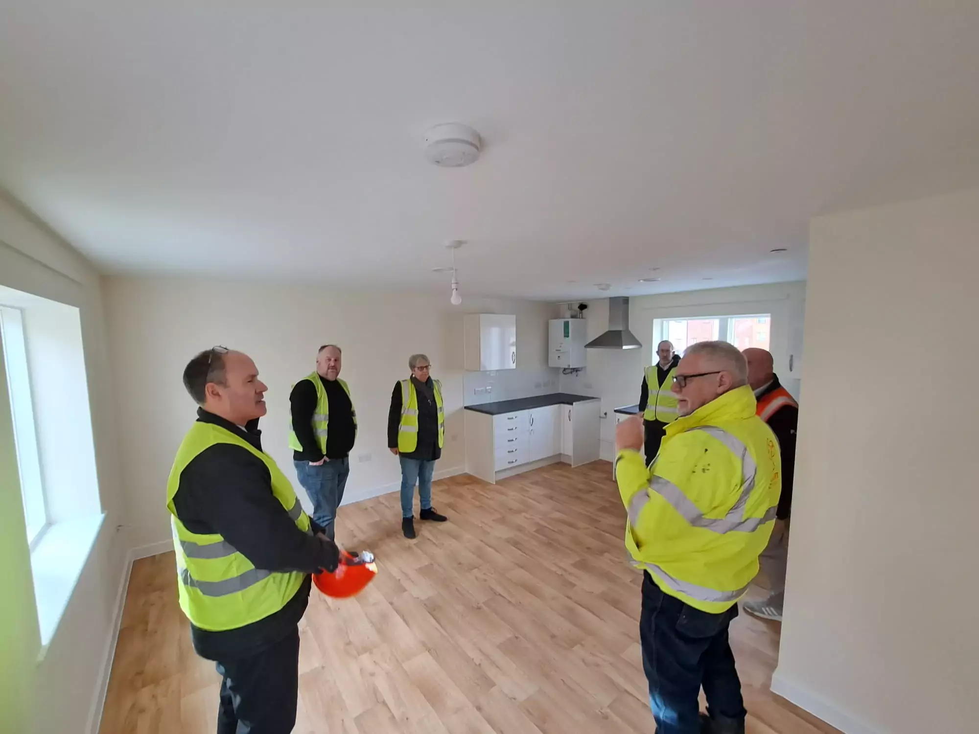 Cllr Robbins and Cllr Howarth touring one of the one-bed flats on the site with council officers