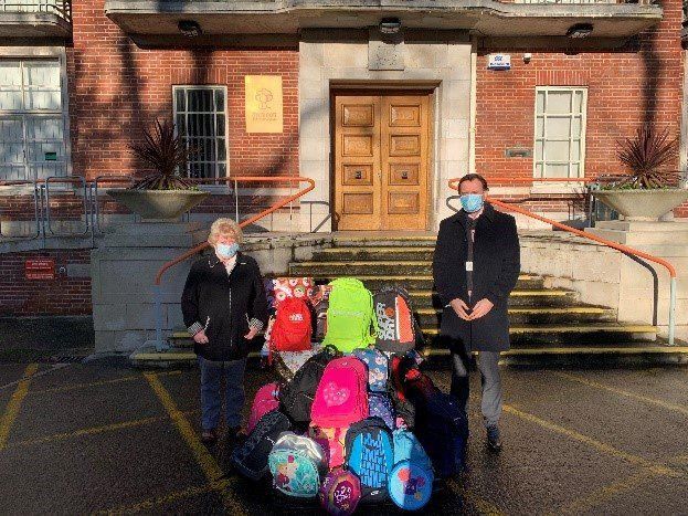 Swindon Borough Council’s Corporate Director of Children’s Services, David Haley, with Dr Brenda Moore, Swindon Rotary Club, with donations of  backpacks and gifts for local children