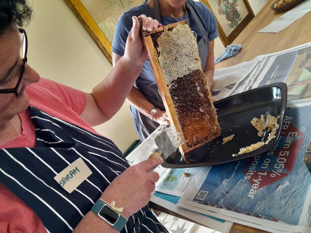 Sarah Watts, a member of Kennet Beekeepers Association (one of four branches across Wiltshire), learning how to process honey from comb to jar.