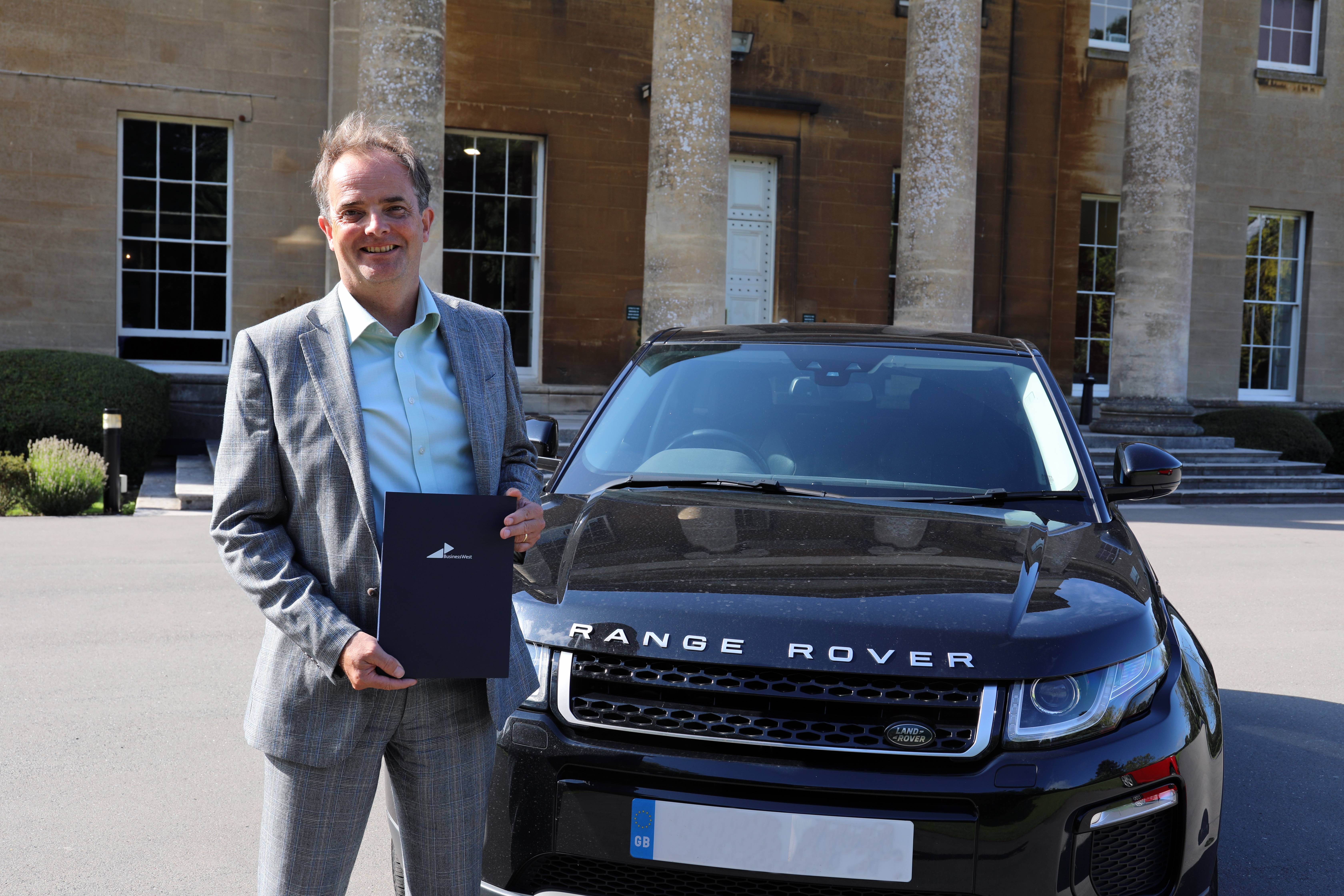 James Monk, Director of International Trade Services at Business West is holding export documentation and is stood by a Range Rover similar to that caught up in the scam