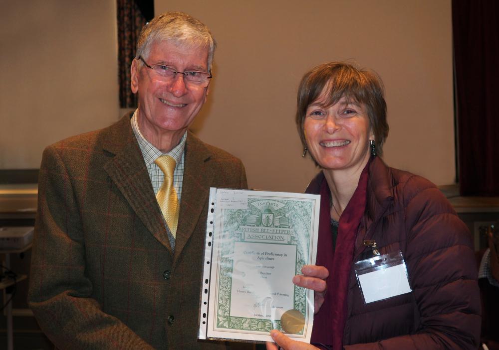 Sophie Butcher receives a certificate in beekeeping at the Wiltshire Bee & Honey Day
